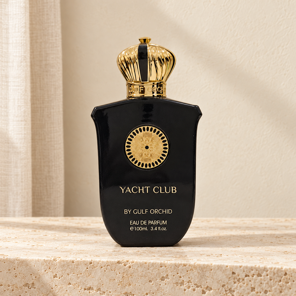 Eau de parfum Yacht Club Gulf Orchid 100 ml, flacon noir et doré sur du travertin dans un décor ivoire – Halya Home